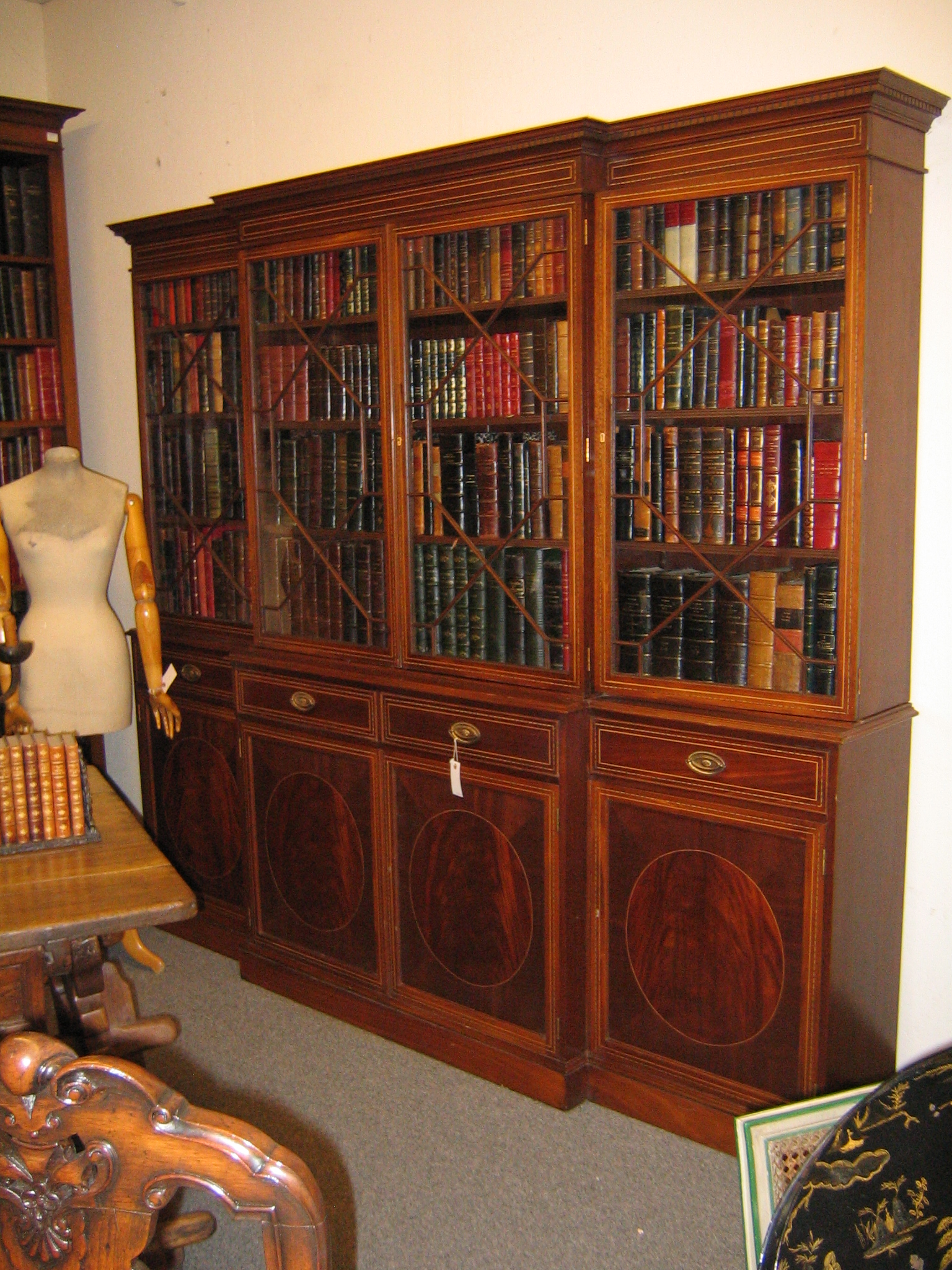 English breakfront in 18th century style. Custom piece in mahogany