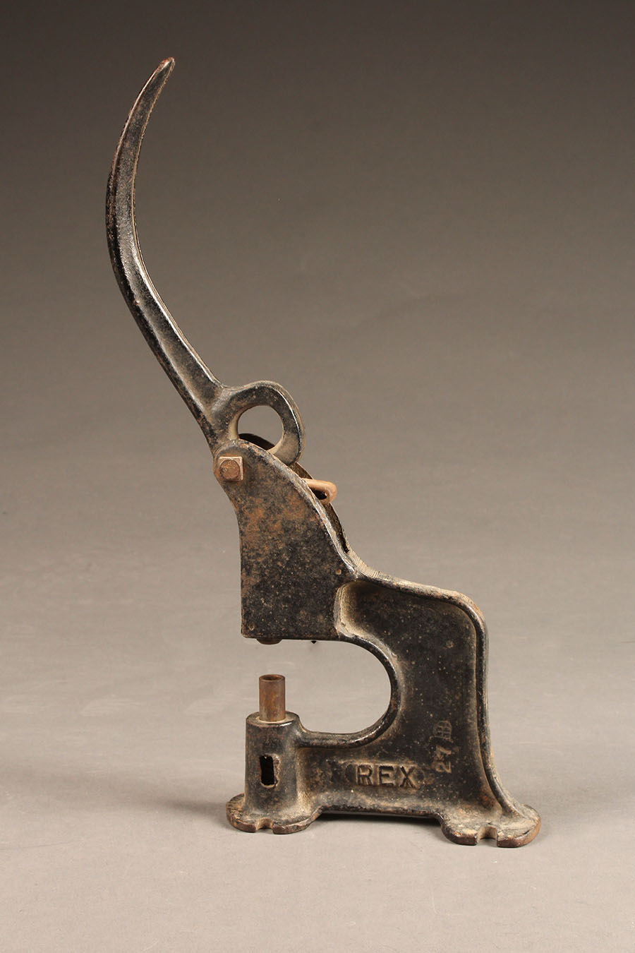 Antique grommet setter made from cast iron.