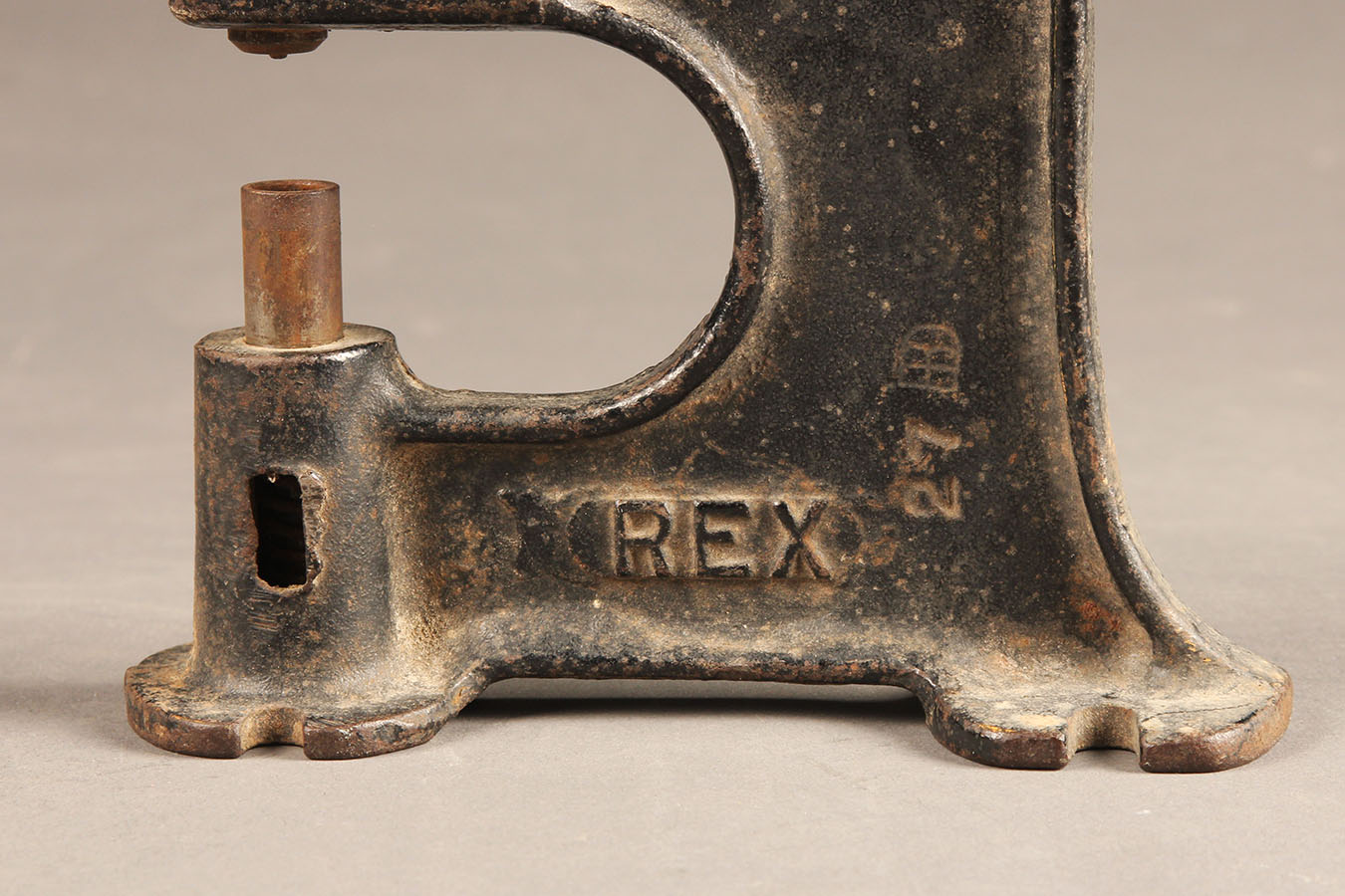 Antique grommet setter made from cast iron.