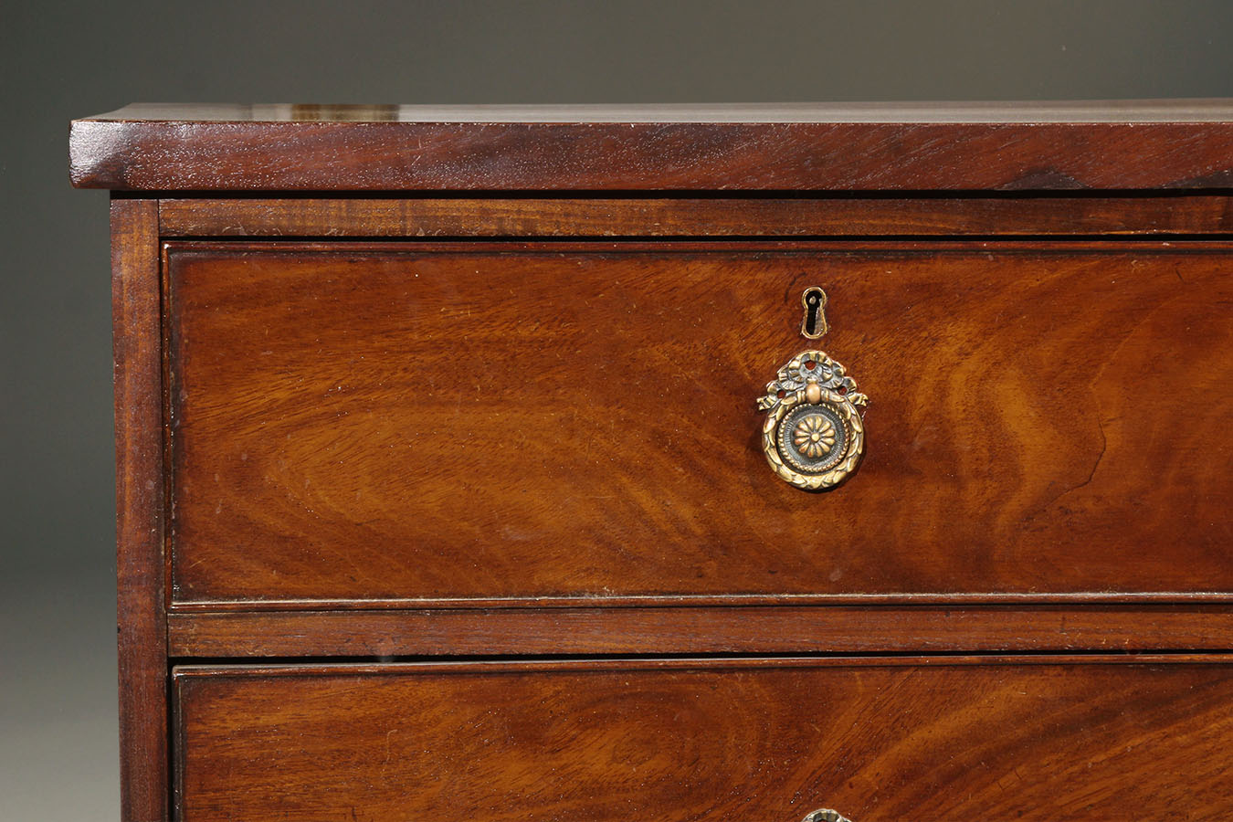 Antique English chest of drawers crafted in beautiful mahogany.