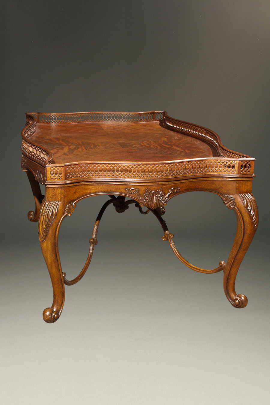 Very nice French style coffee table with wonderful pierce carving and delicate stretcher.