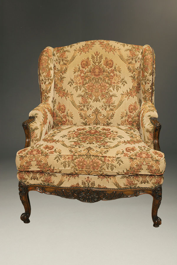 Antique French Louis XV style wingback chair.