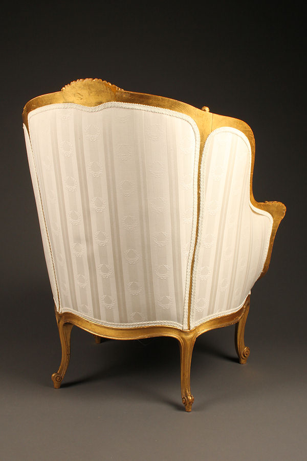 19th century French Louis XV style gilded wing chair.