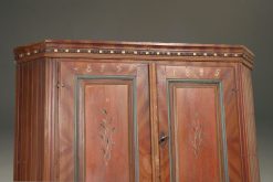 Early 19th century Norwegian pine corner cupboard with original painted finish dated 1825.