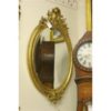 19th century Louis XV oval gilded French mirror with beveled glass