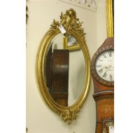 19th century Louis XV oval gilded French mirror with beveled glass