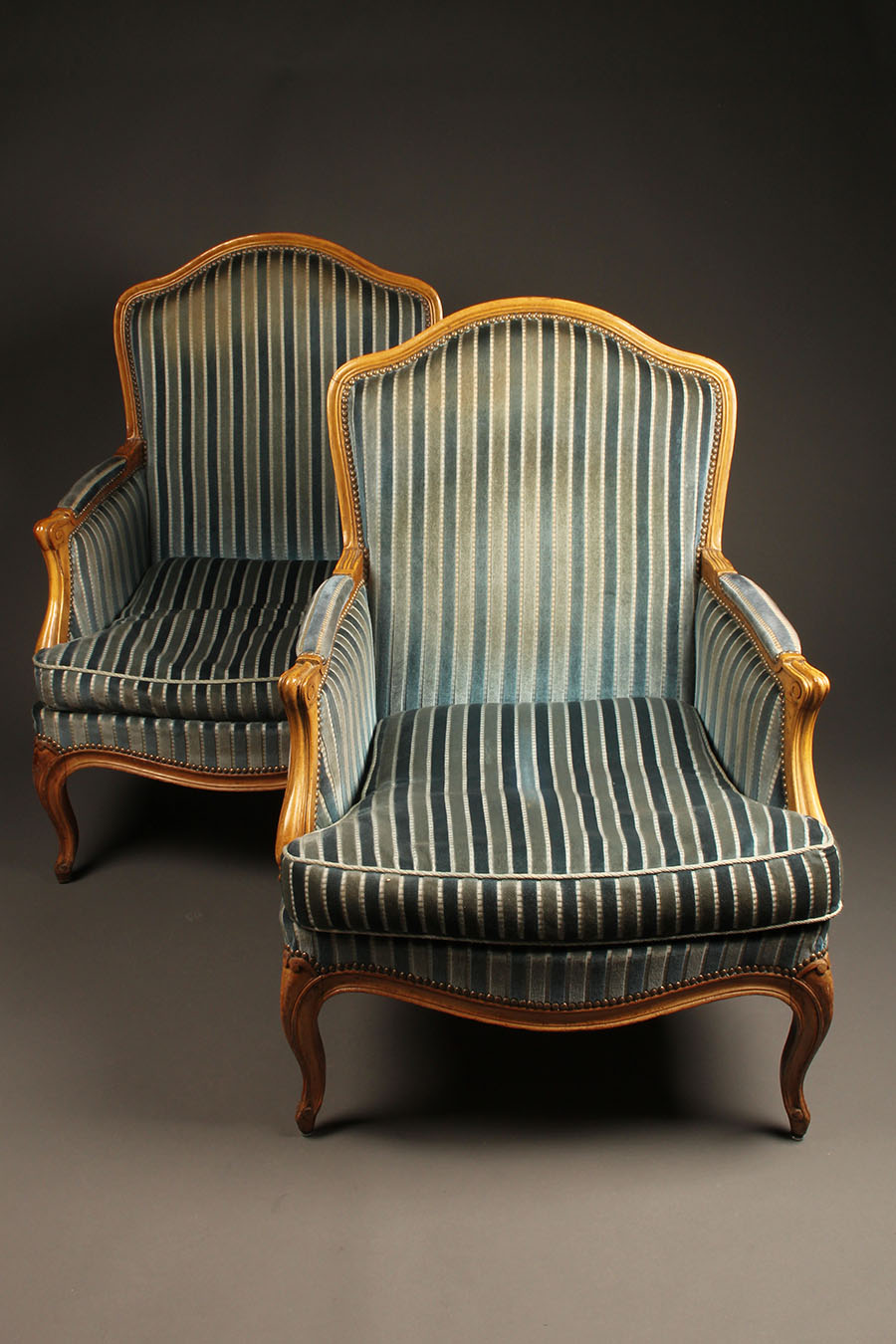 Pair of French Louis XV style bergére chairs with hand carved
