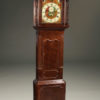 Mid 19th century English tall case clock with plum pudding mahogany case, circa 1860.