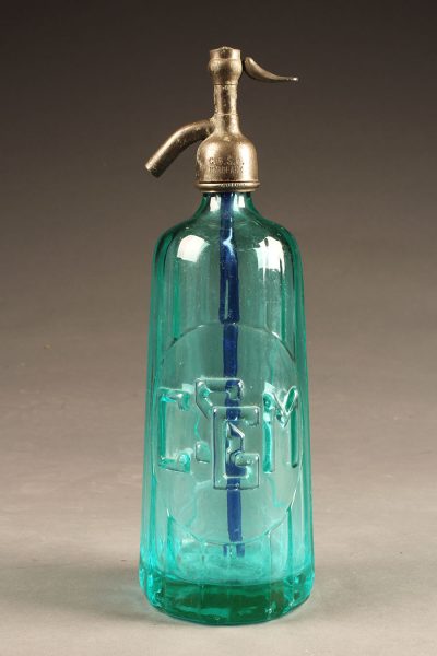 Blue seltzer water bottle from France with raised letters dated 1933.