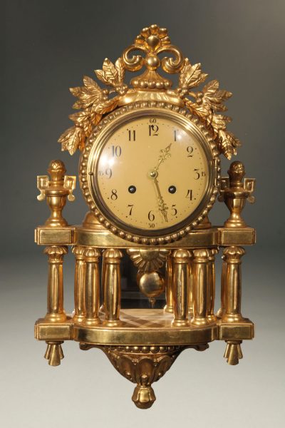 Vintage French Louis XVI style clock with gilded finish.