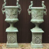 Pair of custom French garden urns with ram heads and puttis.