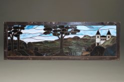 Late 19th century stained and leaded glass panel depicting a castle and trees, circa 1890.