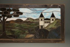 Late 19th century stained and leaded glass panel depicting a castle and trees, circa 1890.