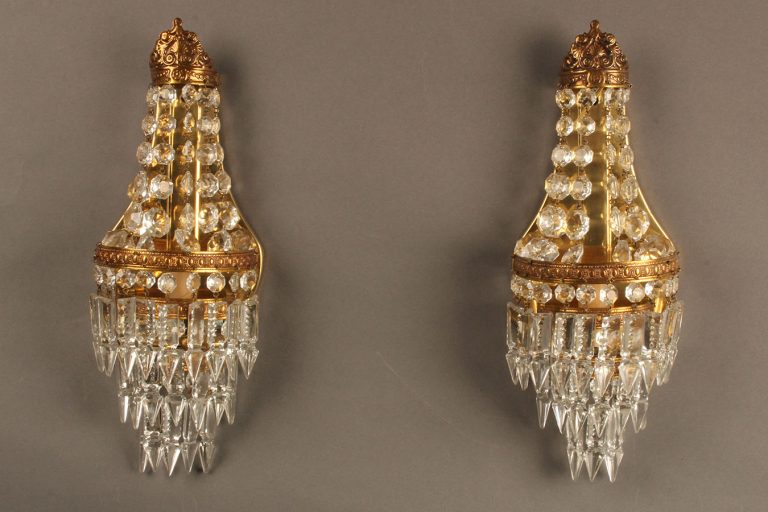 Antique pair of French bronze and crystal sconces.