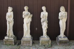 Set of English cast limestone statues representing the four seasons.