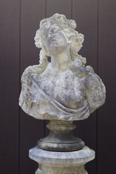 English cast limestone bust of a Bacchante atop a column.