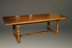 Custom English oak farmhouse table with hand hewn top and turned legs.