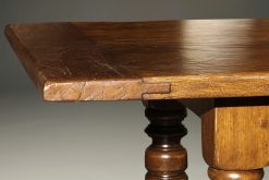 Custom English oak farmhouse table with hand hewn top and turned legs.