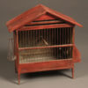 Late 19th century French finch cage with red paint and hand blown glass water bottle