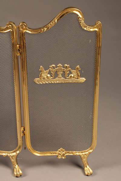 Solid brass folding fireplace screen with ornate castings.