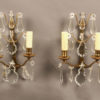 Pair of French 2 arm bronze and crystal sconces.