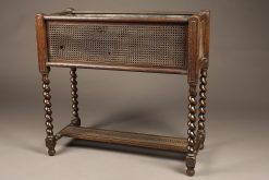 Early 20th century jardiniere in caned oak with liner and writhen legs