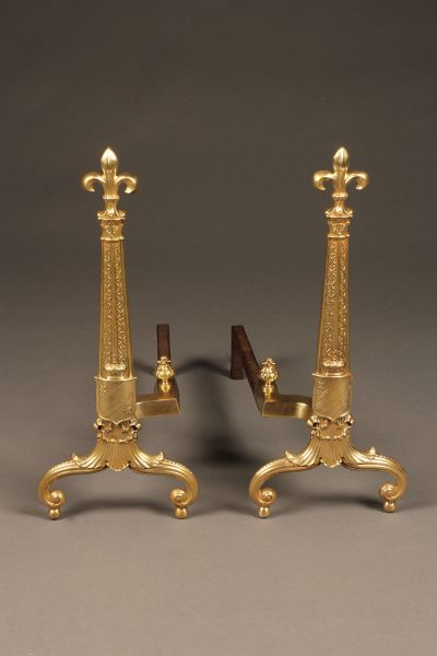 Pair of bronze andirons in fleur-de-lis motif.