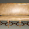 Banquette by Century Furniture company featuring hand carved frame and distressed leather upholstery