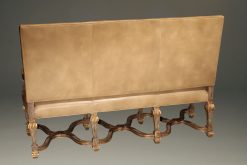 Banquette by Century Furniture company featuring hand carved frame and distressed leather upholstery